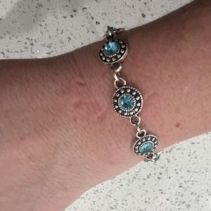 Multiple blue bracelets, blue necklaces, and earrings